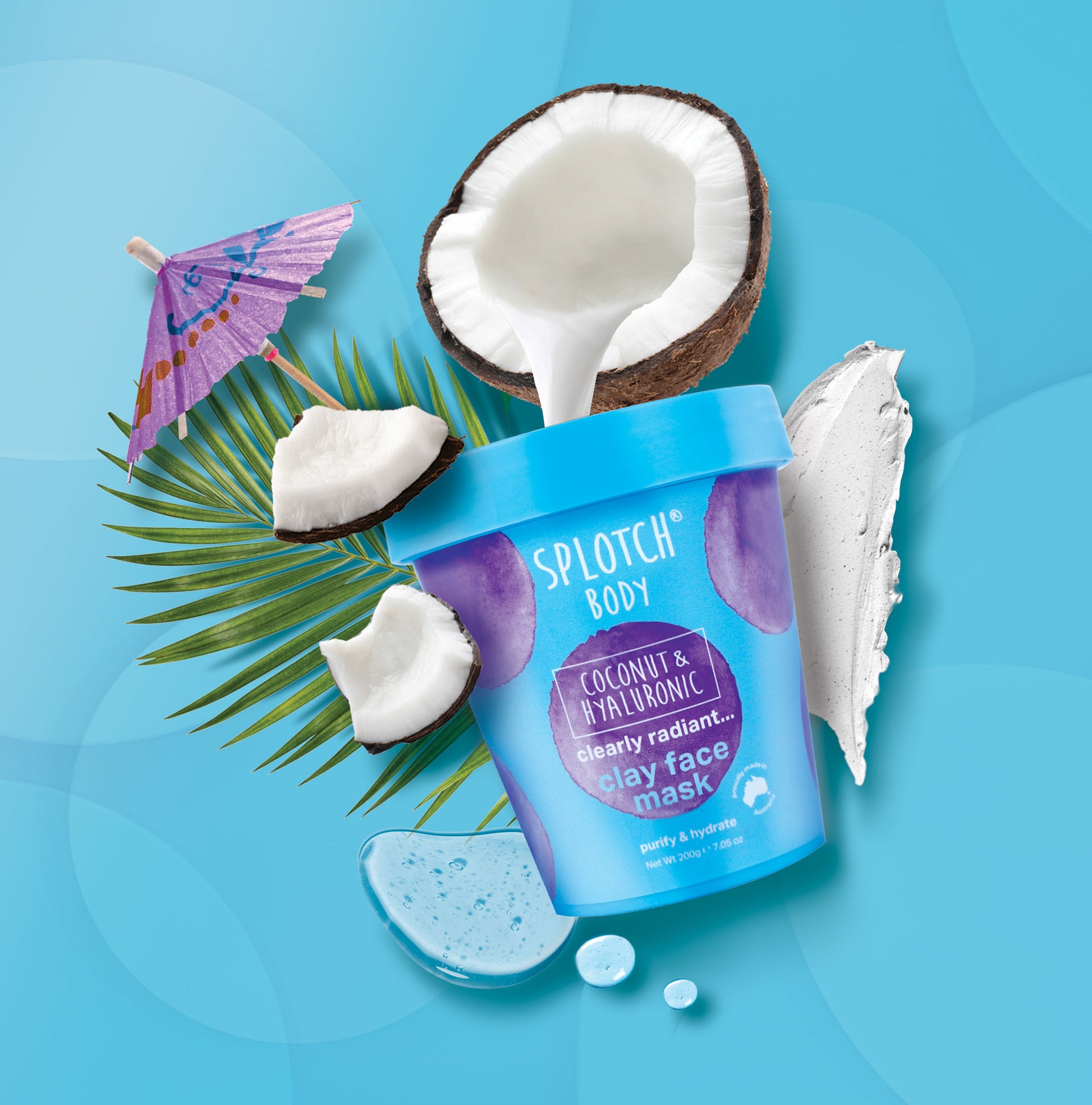 Splotch Body Coconut & Hyaluronic Clay Face Mask with coconut halves and a palm leaf on a blue background