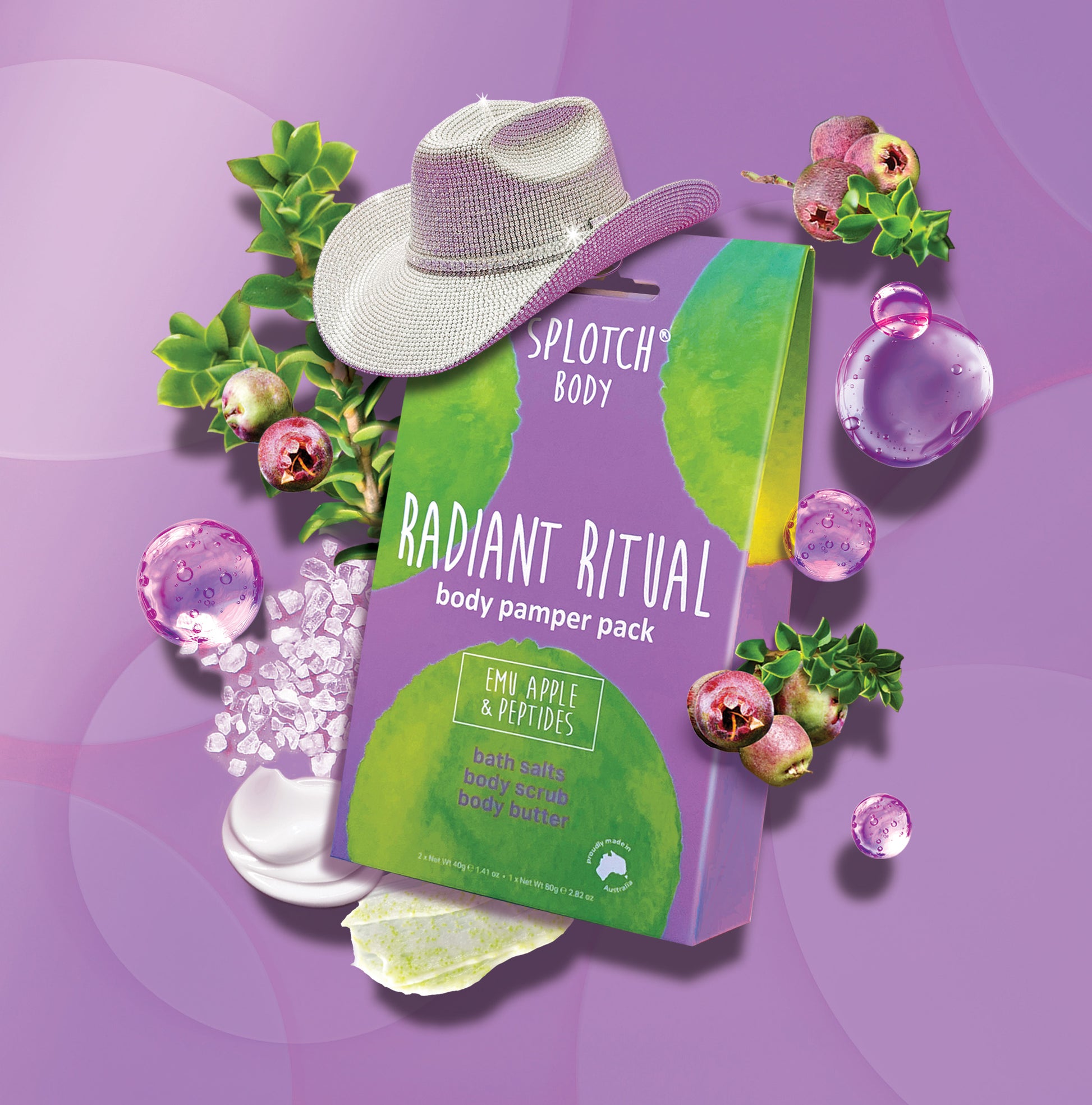 
A stylised product photo of a purple box for the SPLOTCH BODY "RADIANT RITUAL" body pamper pack, which contains bath salts, body scrub, and body butter, all featuring Emu Apple & Peptides. A sparkly silver cowboy hat rests on top of the box. The scene includes Emu Apple berries, green leaves, scattered bath salts, purple water bubbles, a dollop of white cream, and a swipe of yellow-green product, all set against a purple background.