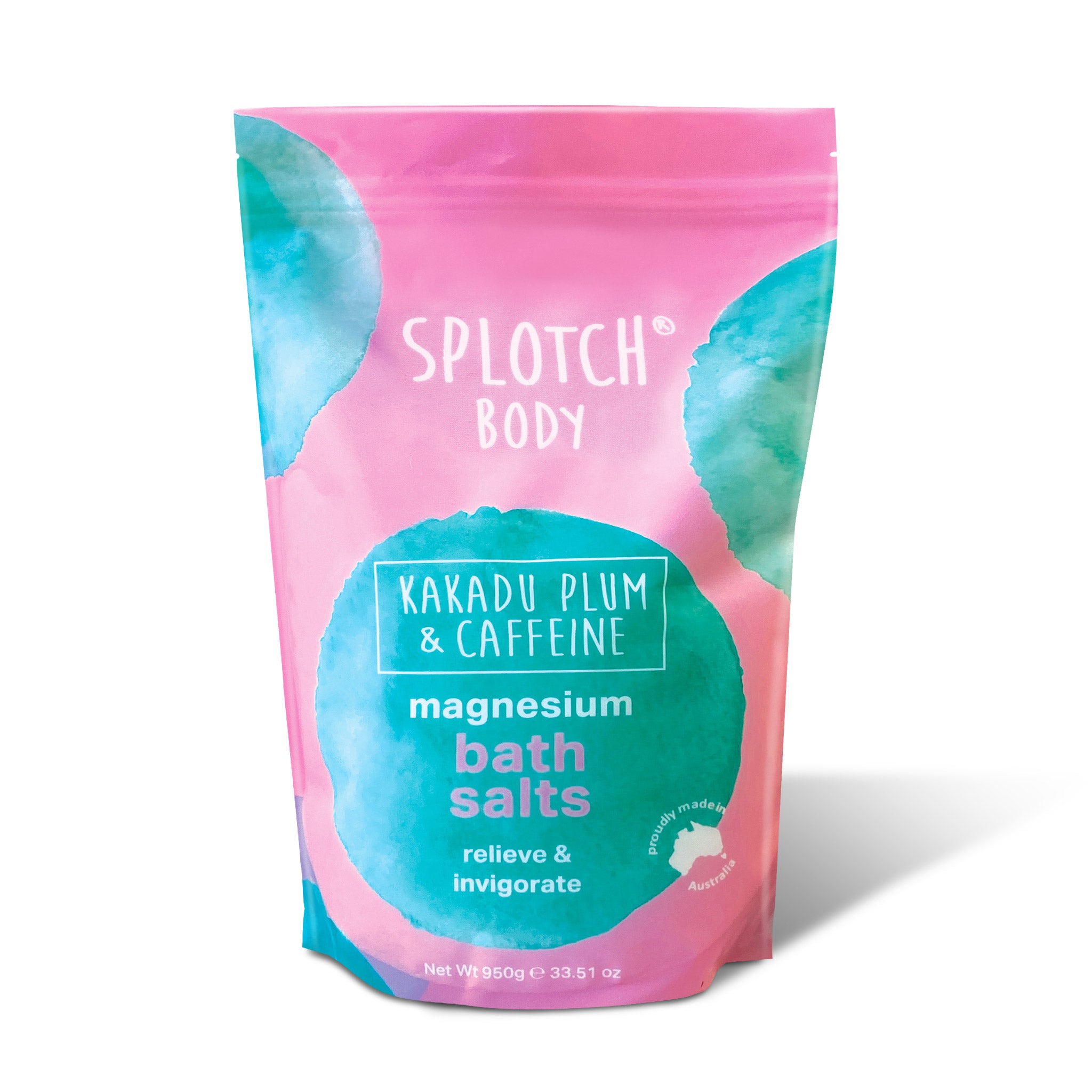 A pink pouch of SPLOTCH BODY magnesium bath salts with a teal and white label. The text reads: "SPLOTCH BODY," "KAKADU PLUM & CAFFEINE," "magnesium bath salts," and "relieve & invigorate". The net weight is 950g 33.51oz.
