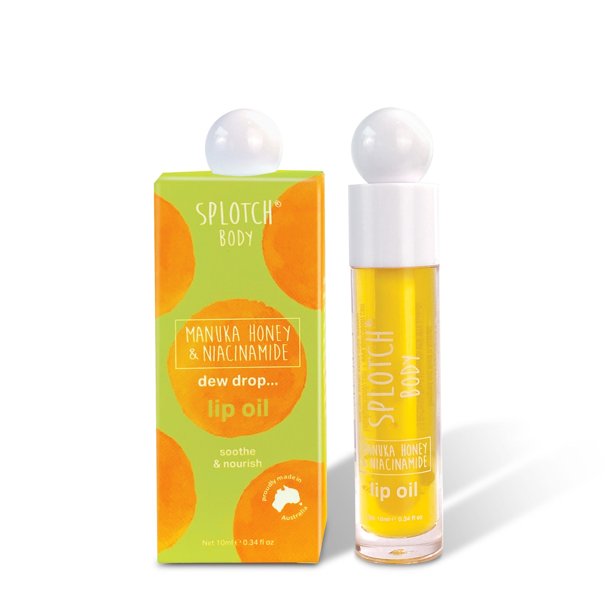 A SPLOTCH BODY Manuka Honey & Niacinamide Lip Oil product set featuring a clear glass tube of yellow lip oil alongside its lime green and orange watercolor-patterned box. Both the box and the tube are capped with a white, spherical pump lid.