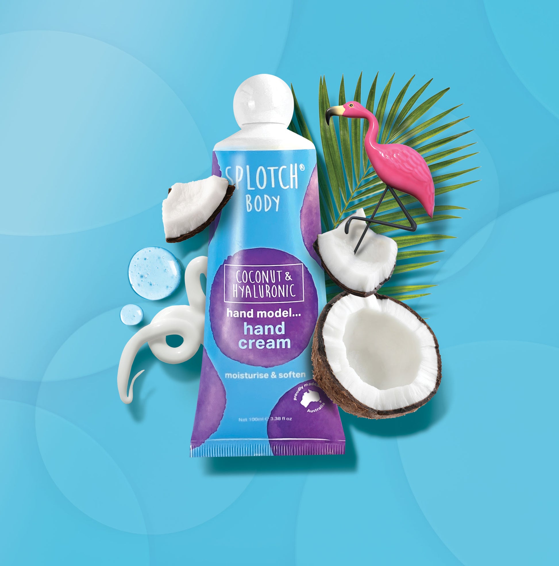 Splotch Body Coconut & Hyaluronic hand cream with coconut halves and a flamingo on a blue background