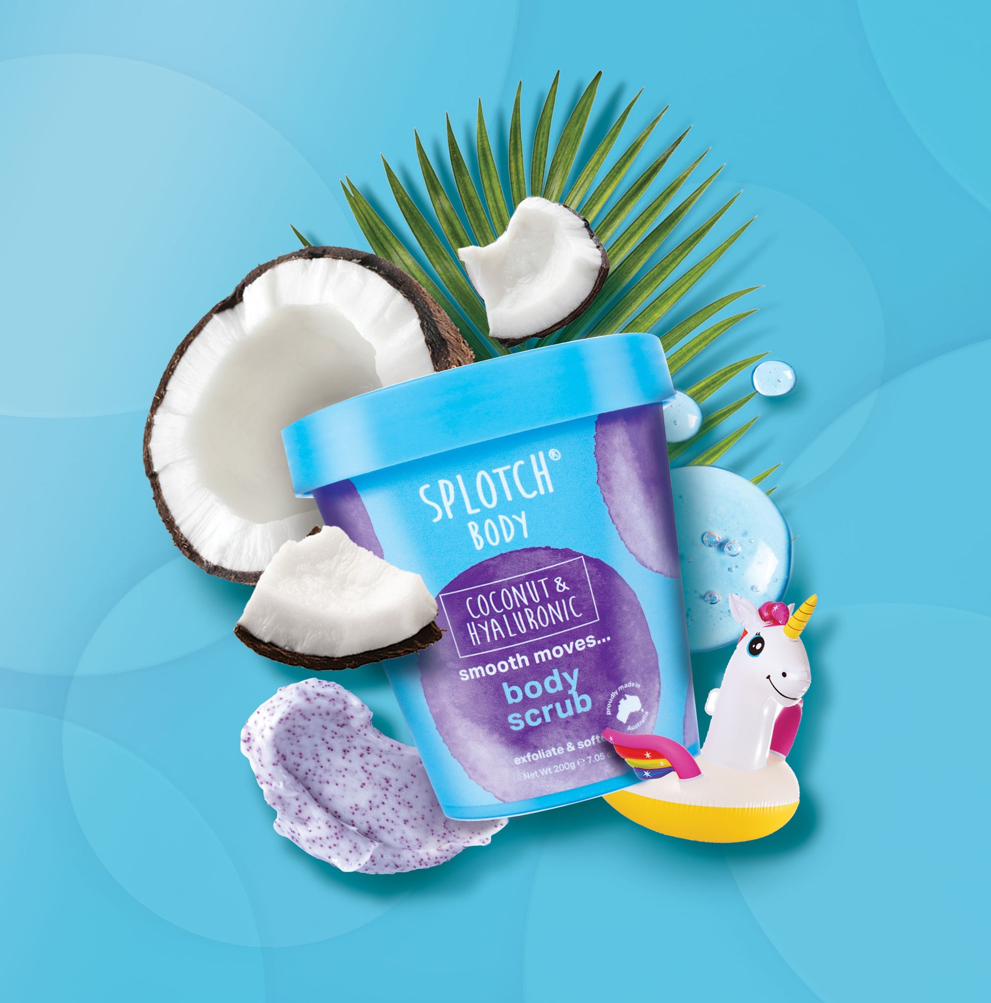 Splotch Body Coconut & Hyaluronic scrub with coconuts and a unicorn toy on a blue background